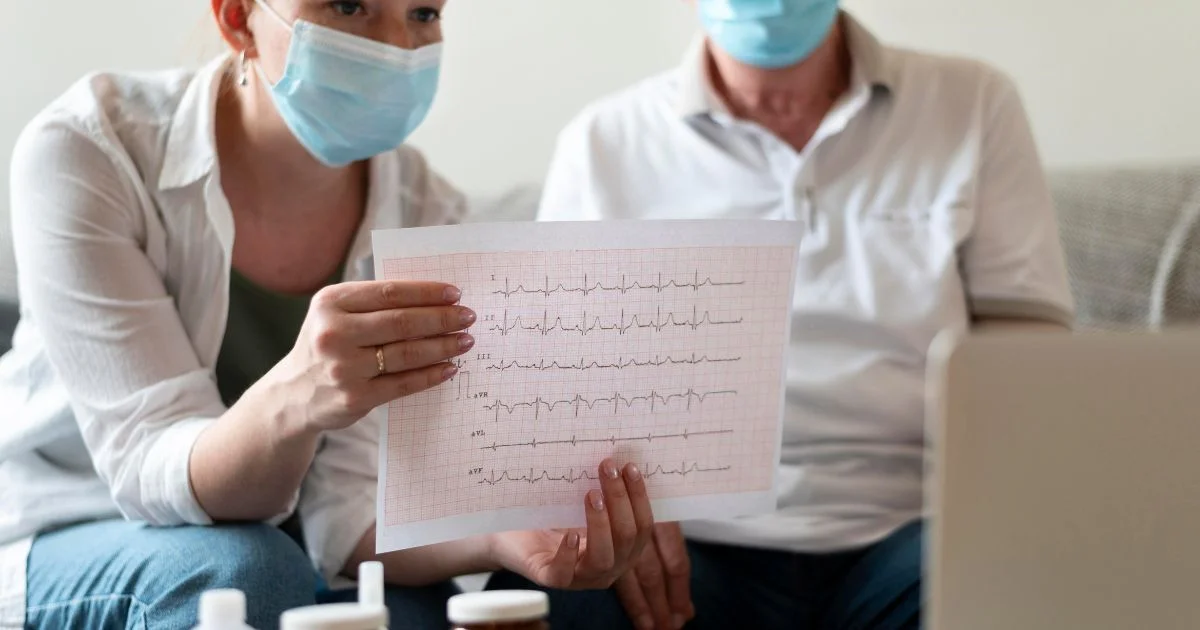 Woman showing ECG chart during telehealth consultation at home
